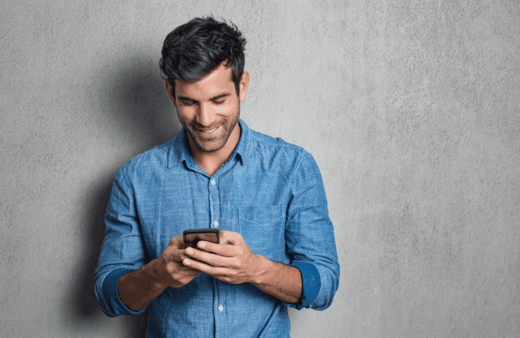 A man using a smartphone to apply for no credit check loans in Ontario